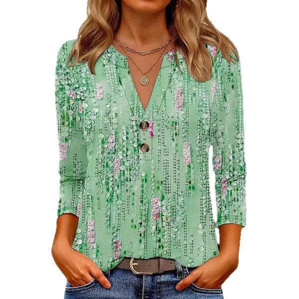 Women's loose grey V-neck t-shirt with a colourful 3D geometric pattern print on the front.