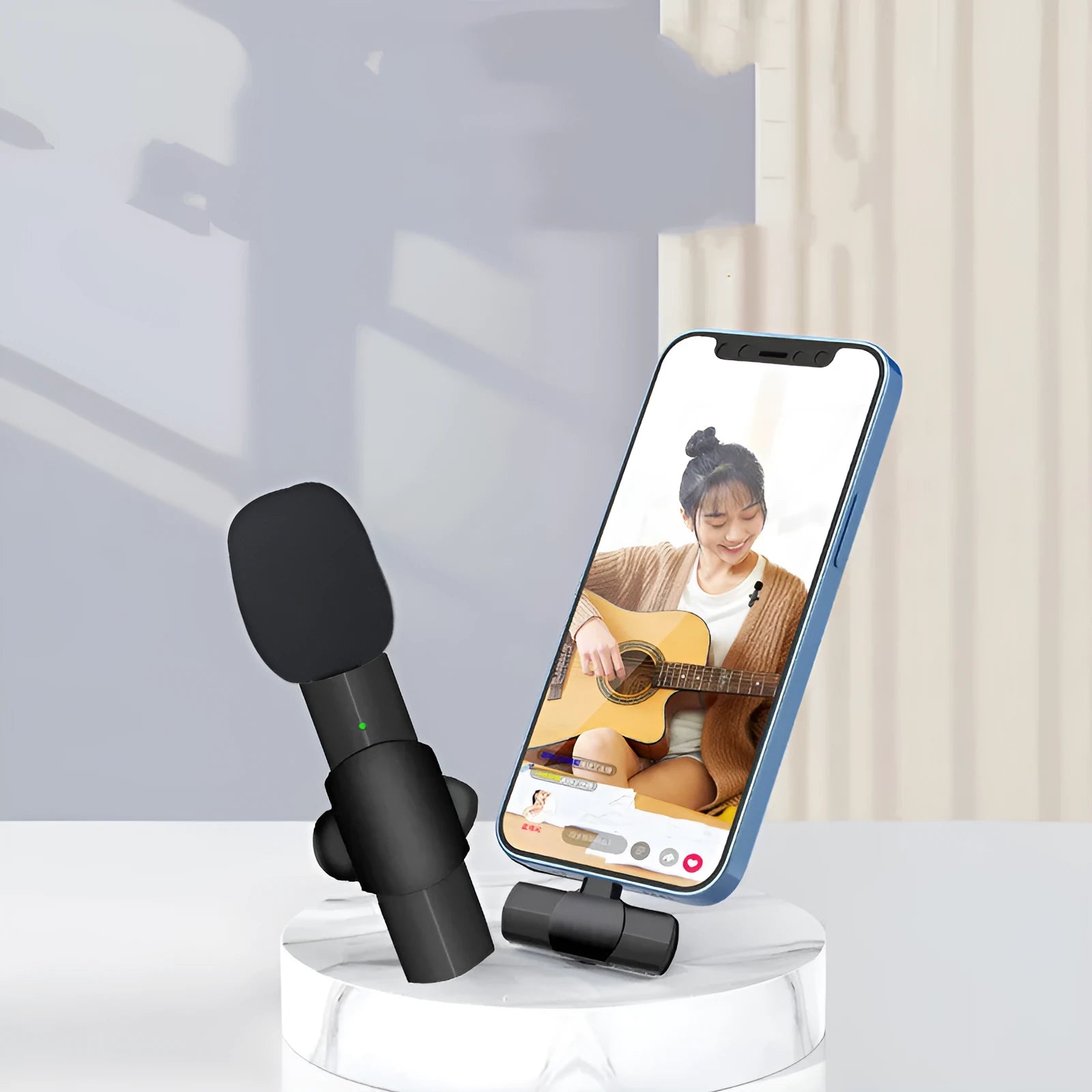 Close-up of a black wireless lavalier microphone with a clip, showing the TYPEC and Apple interface options on a mobile phone.