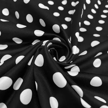 Multicolour polka dot dress with square collar, short sleeves, front zipper, and a pleated mid-length skirt on a hanger.