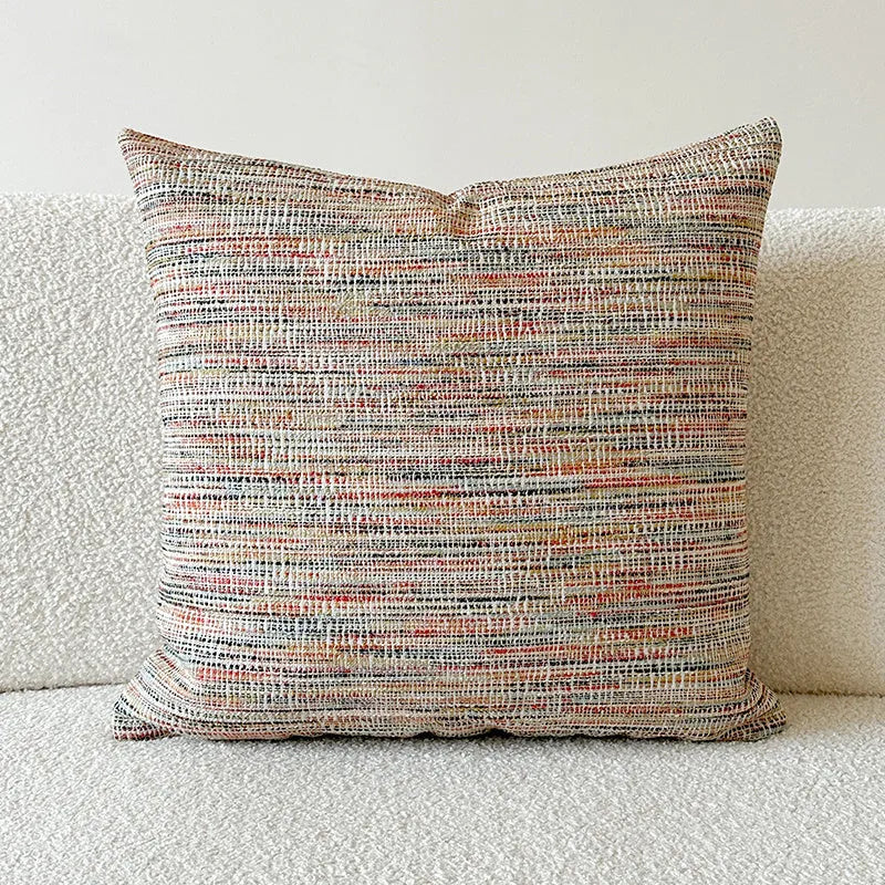 Amber American-style jacquard pillow cover with paisley and flower pattern on a sofa.