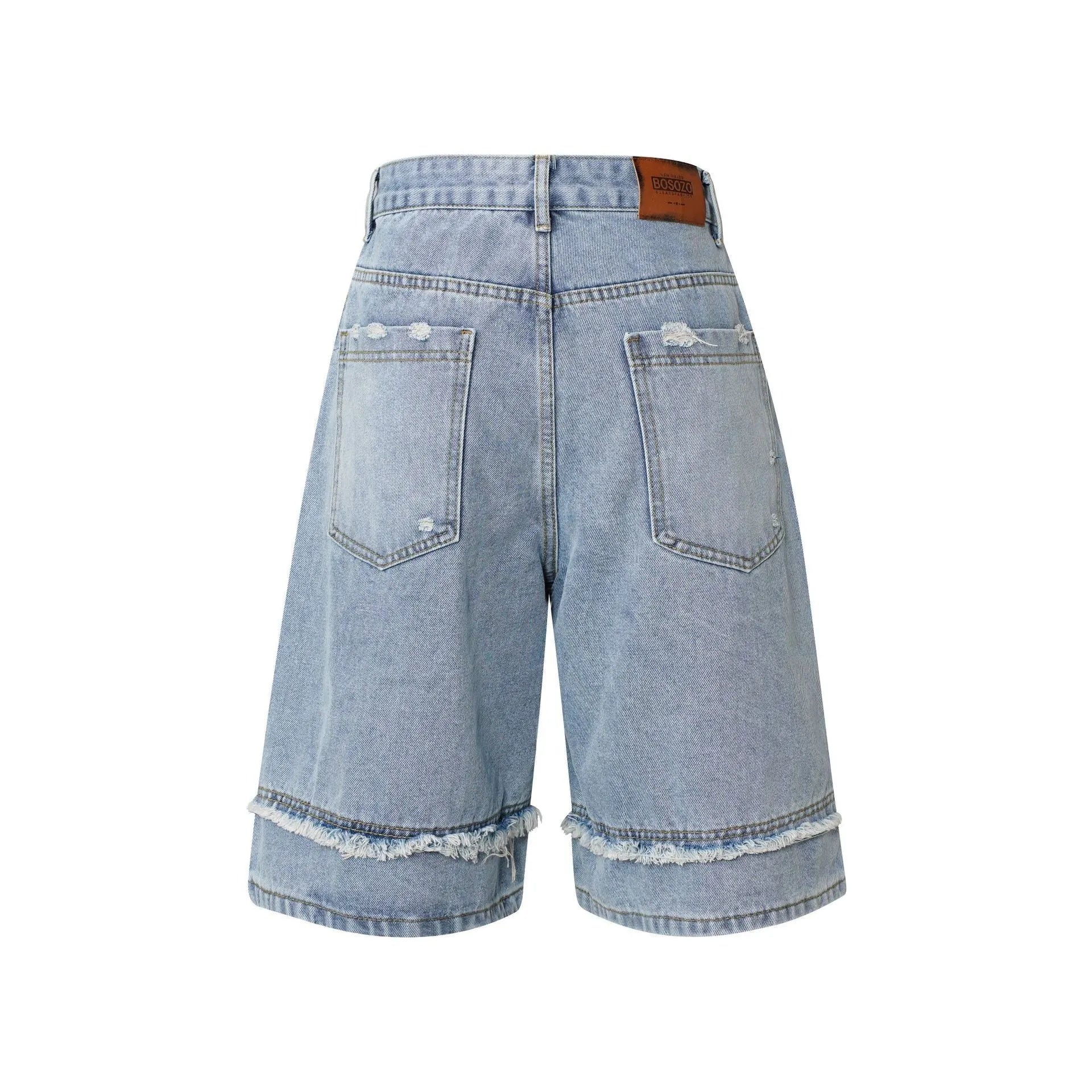 Distressed raw edge denim shorts in light blue on a mannequin, showing straight cut and cropped length.