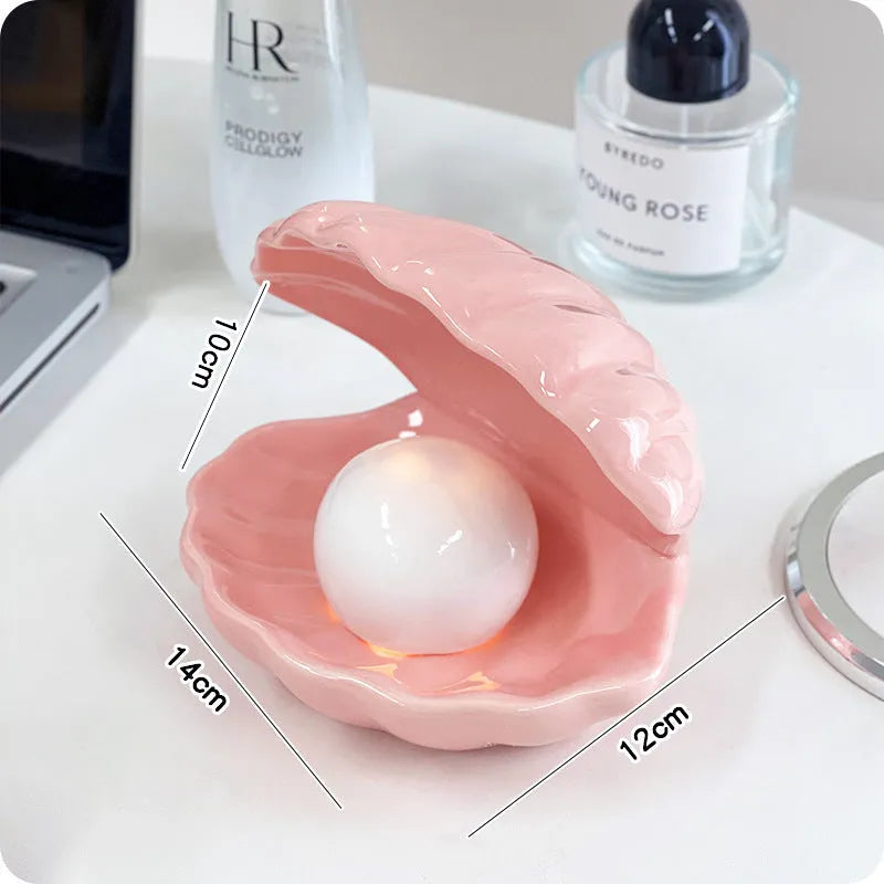 White porcelain storage tray with optional small night light, shown in pink and white shell colours on a wooden surface.