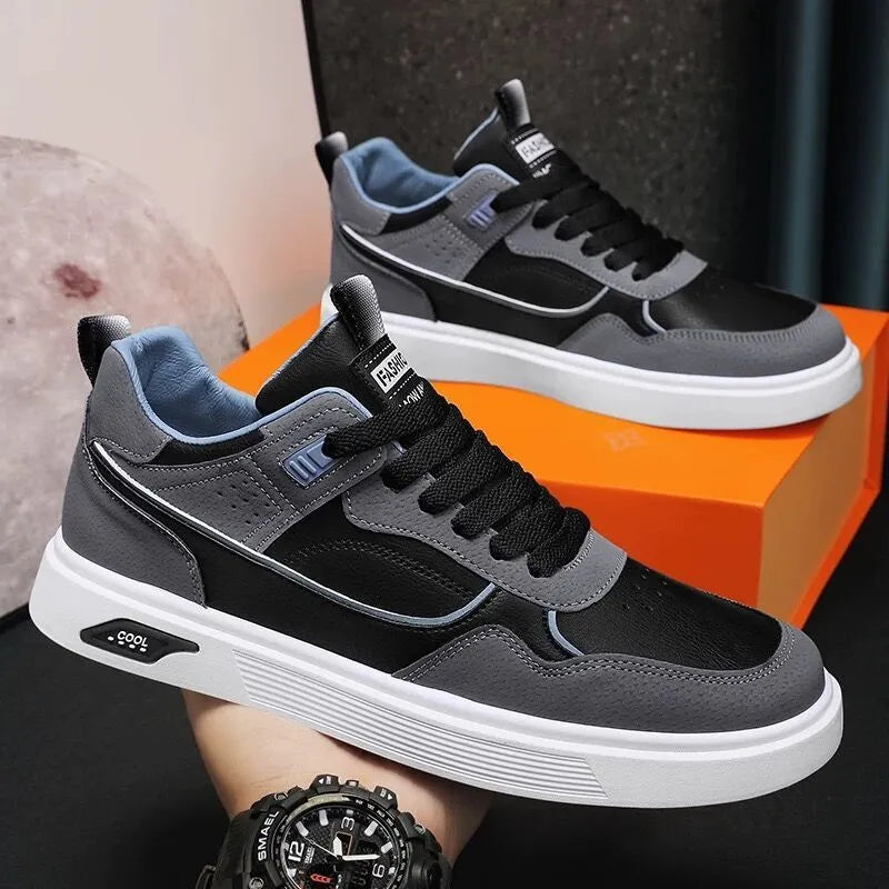 Men's low-top beige canvas board shoes with leather stitching details on a white background.