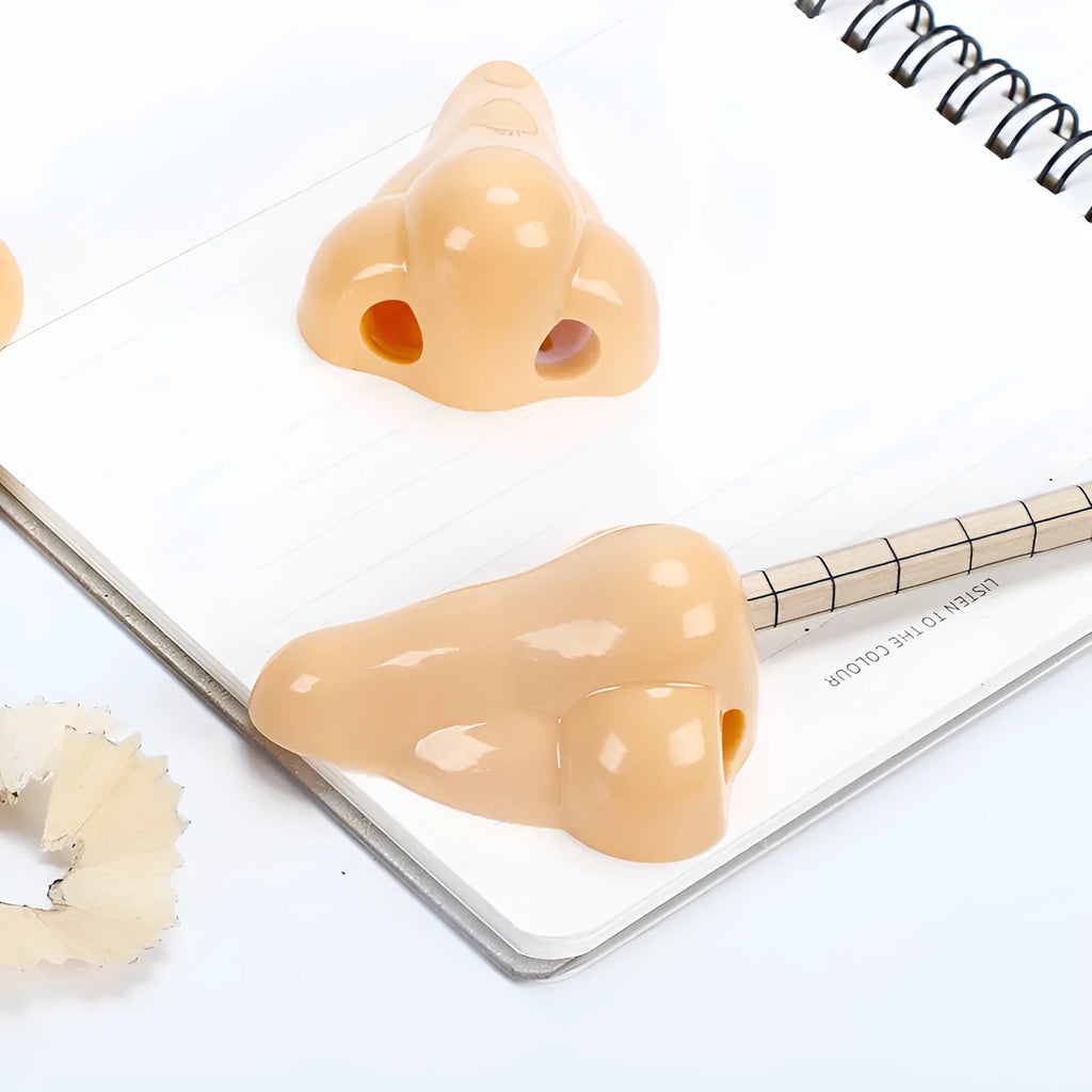 Flesh colour geometry-shaped plastic pencil sharpener for manual use.