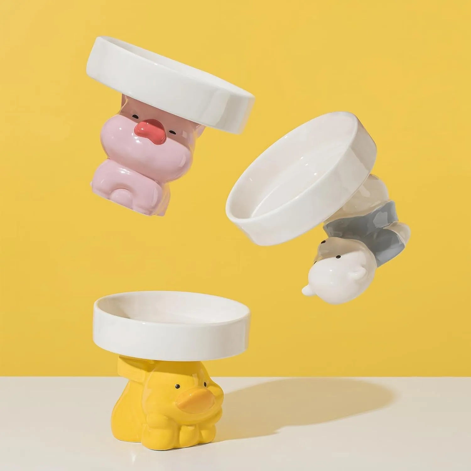 Raised ceramic pet bowl in animal design, showing wide shallow dish on elevated base.