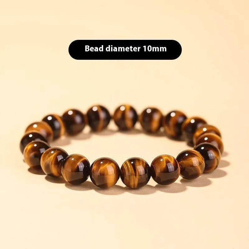 Single circle ethnic Tigereye bead Buddha rosary bracelet on a wrist, showing unisex design.