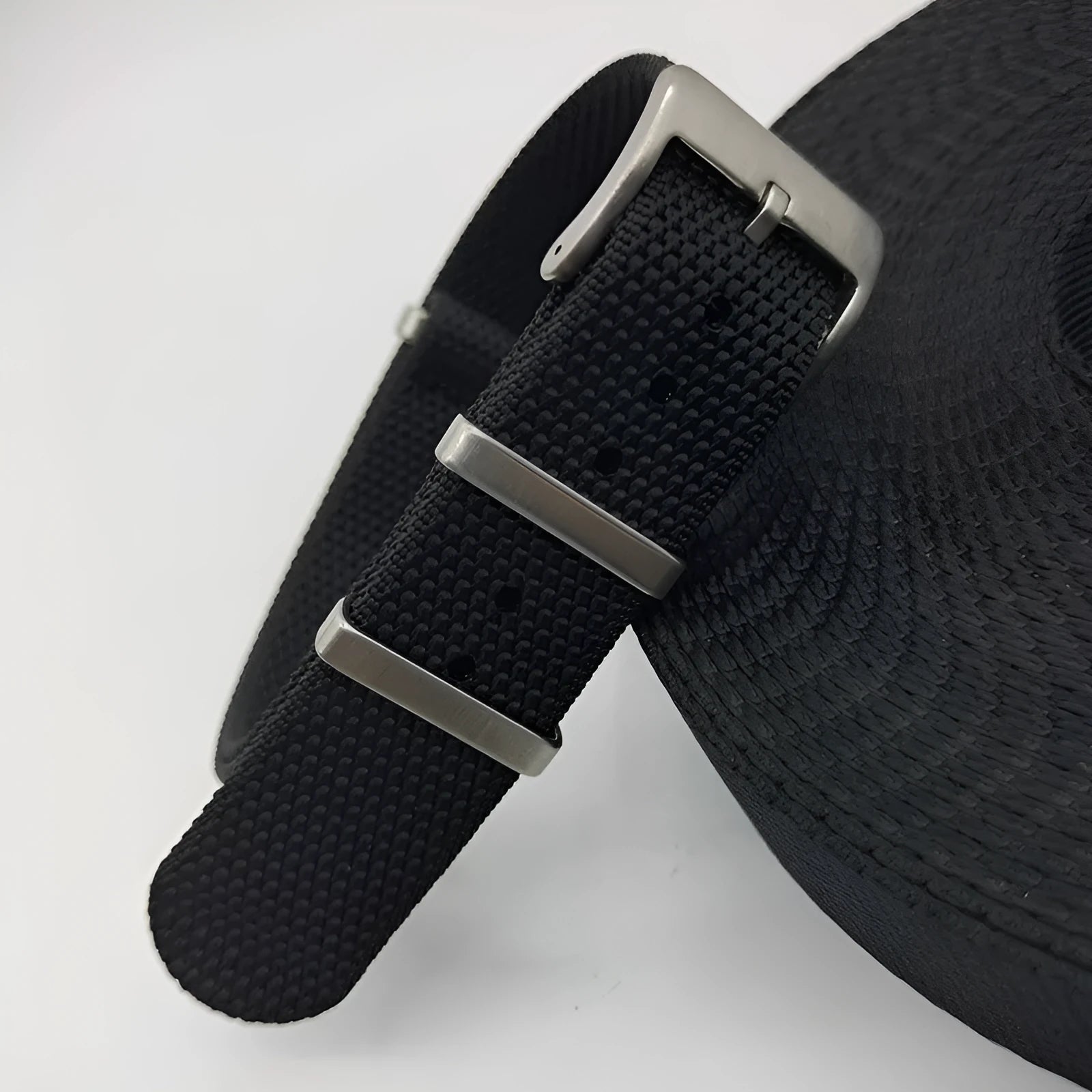 Nylon integrated watch strap in army green colour showing textile texture and buckle.