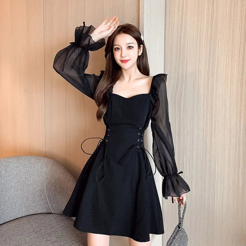 White chiffon patchwork dress with long sleeves and a waist-slimming fit on a mannequin.
