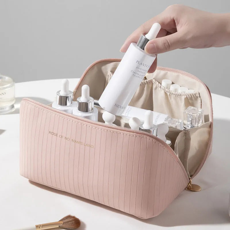 Vertical pattern pillow makeup bag in beige, black, brown, grey, or pink, showing cubic 22.5cm shape.