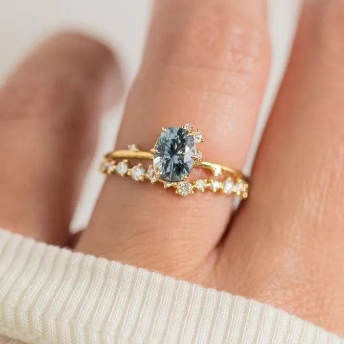 Gold plated women's ring with green zircon stone in floral design on model finger