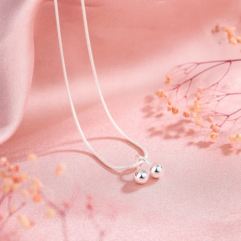 Silver cherry necklace for women on a snake bone chain, adjustable length.
