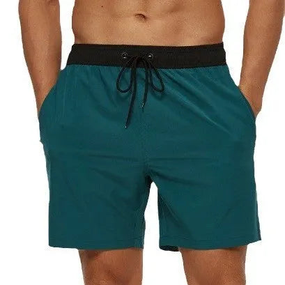 Men's blue fitness shorts with a drawstring waistband and a side zipper pocket.