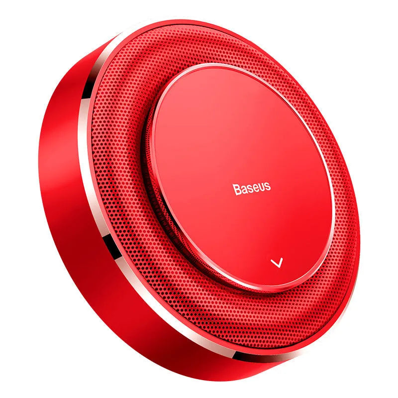 Round black aluminium alloy Bess car fragrance unit placed on a car seat.