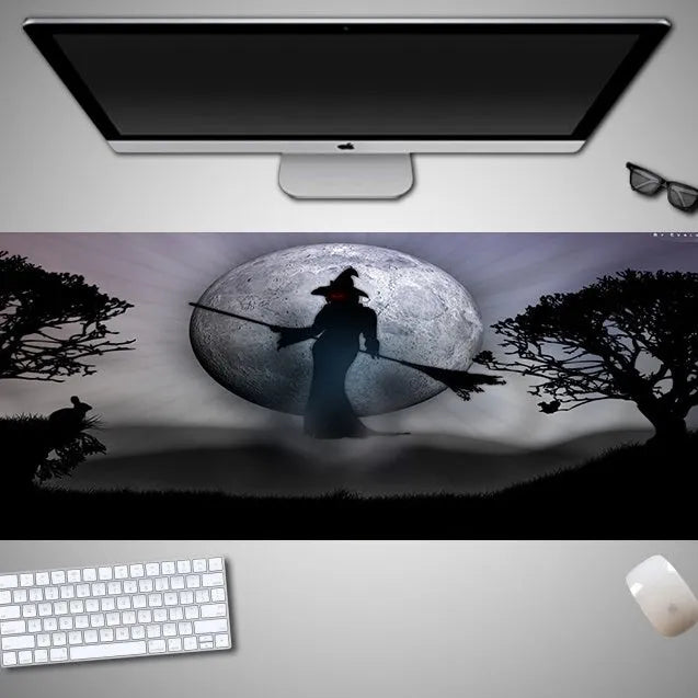 Large Halloween patterned gaming mouse pad on a desk showing non-slip rubber base and extra-long design.