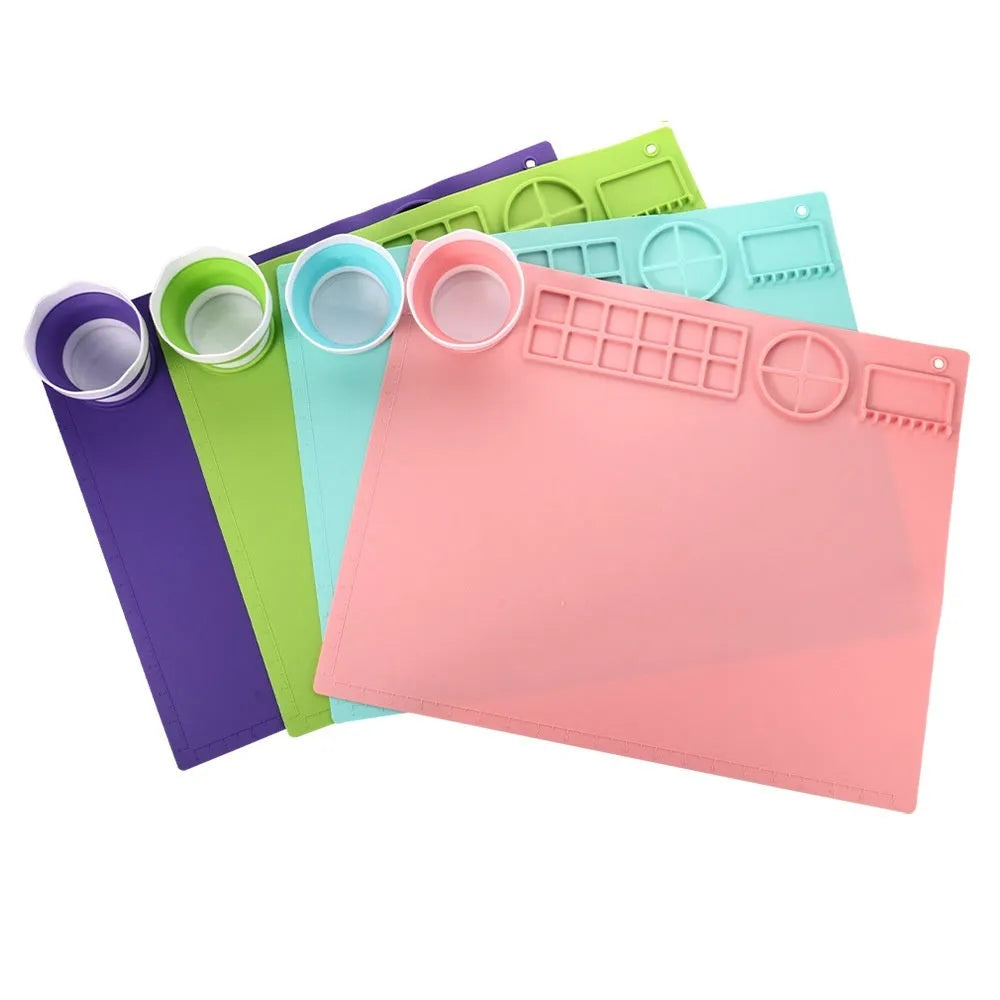 Green silicone painting mat measuring 50 by 40 cm, shown with two integrated bowls for paint or water.
