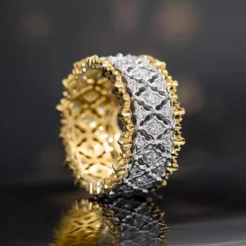 A geometric two-tone gold zircon ring on a hand, showing its round design and copper construction.