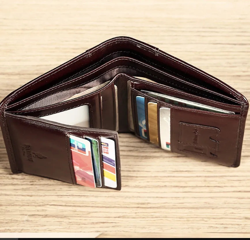 Men's black full-grain leather bifold wallet open, showing card slots, zip coin pocket, and banknote section.