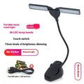 Black rechargeable music stand lamp with 28 LEDs clipped to a metal stand.