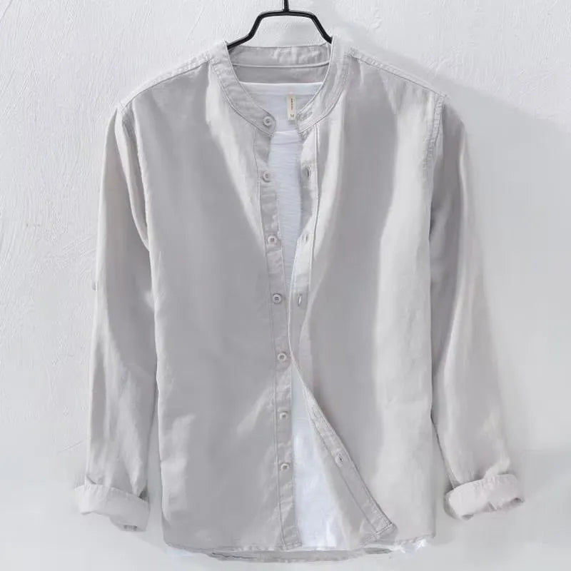 A man's loose-fitting, long-sleeve casual shirt in a cotton linen blend, shown in a solid colour.