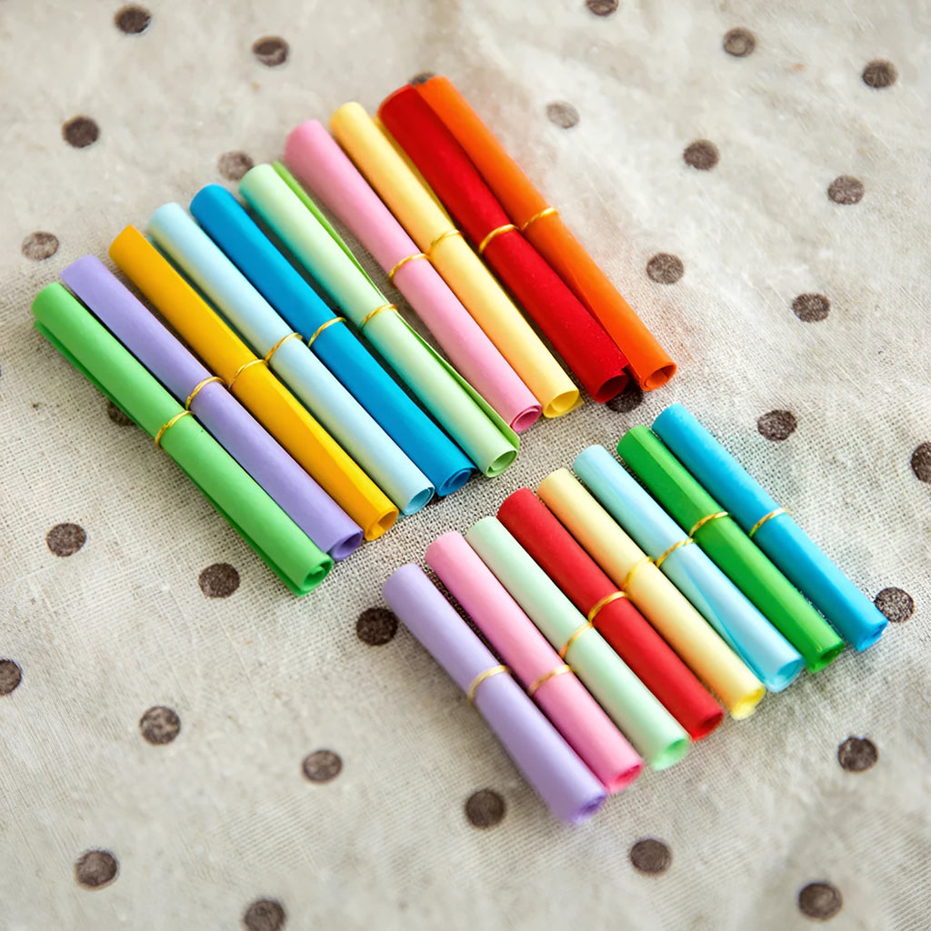 Colourful mini letter paper scrolls with eyelet holes for bottle messages in multiple sizes