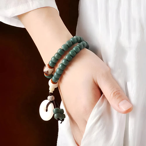 White jade green Bodhi seed bracelet with a safety buckle and lotus charm.