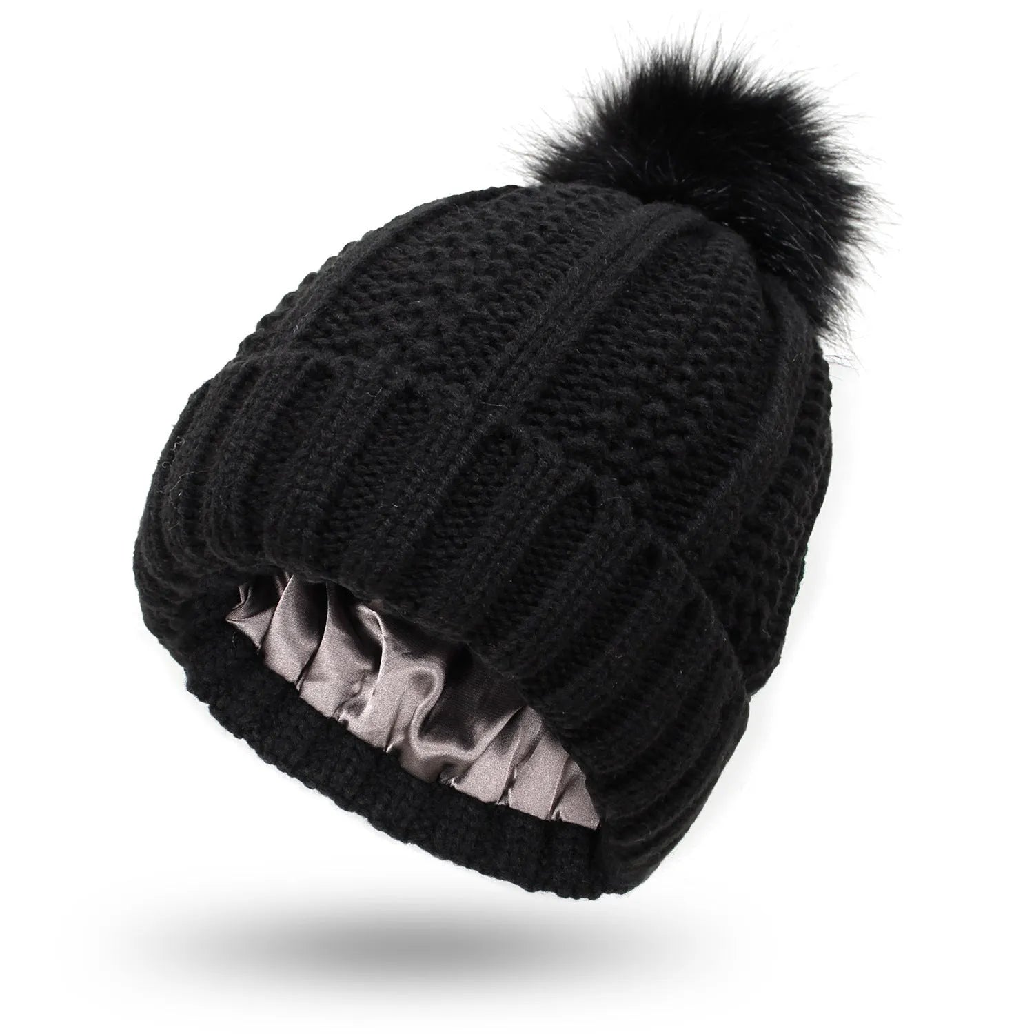 Women's knitted beanie hat with faux fur pom pom and satin lining in multiple colour options.