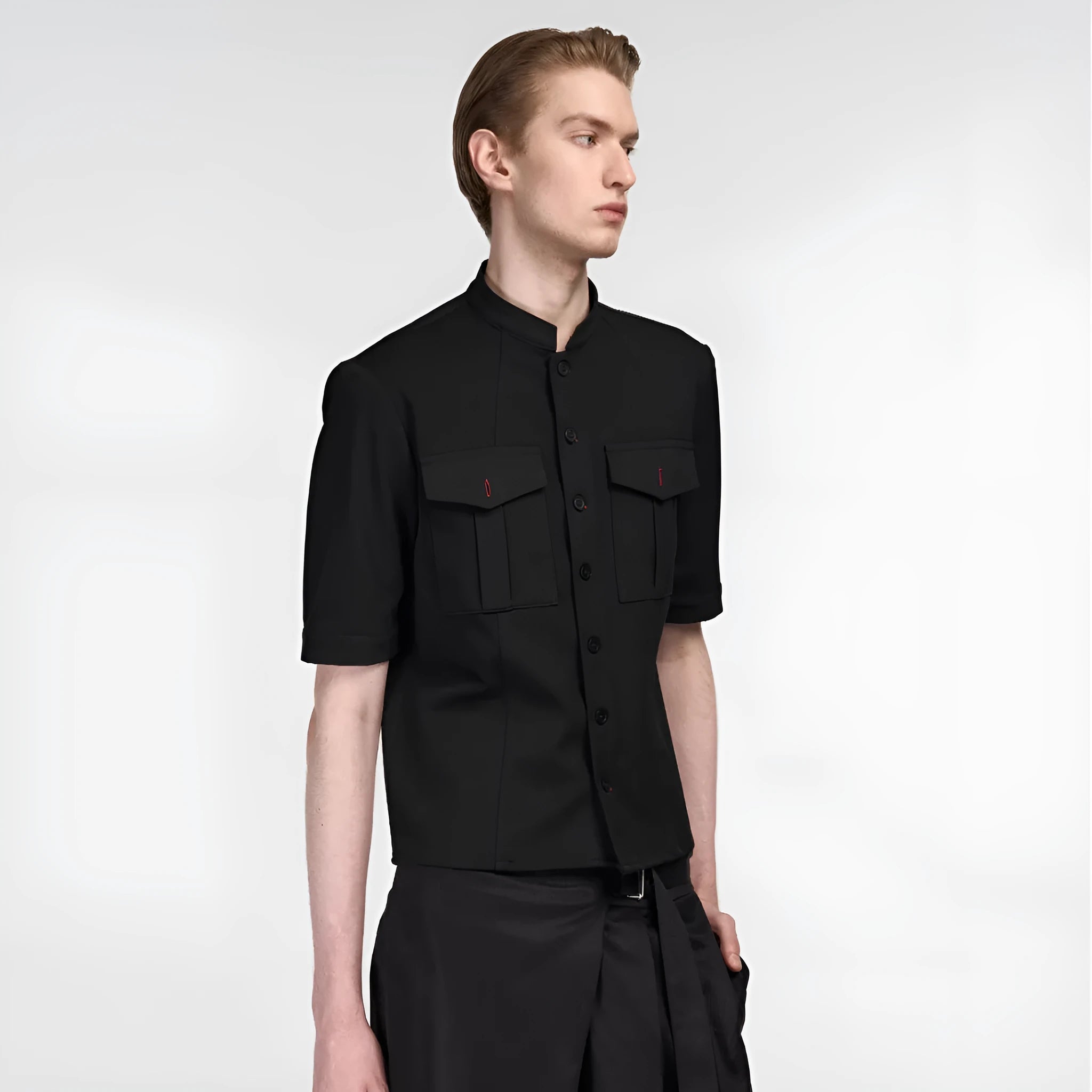 A black loose fit half sleeve hunting shirt with a shirt collar on a hanger.