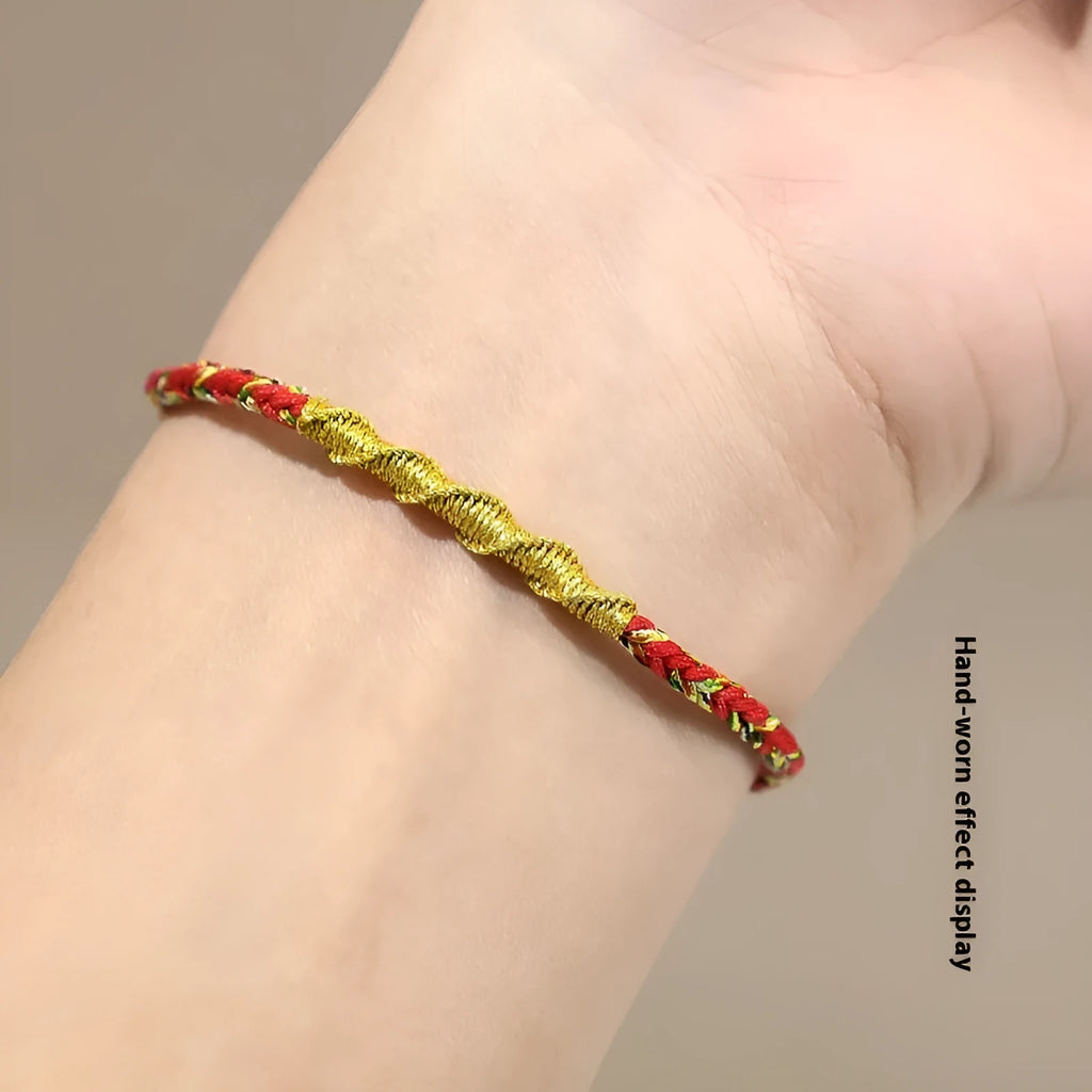 Close-up of an adjustable eight-strand woven hand strap in a zodiac-themed colour on a wrist.