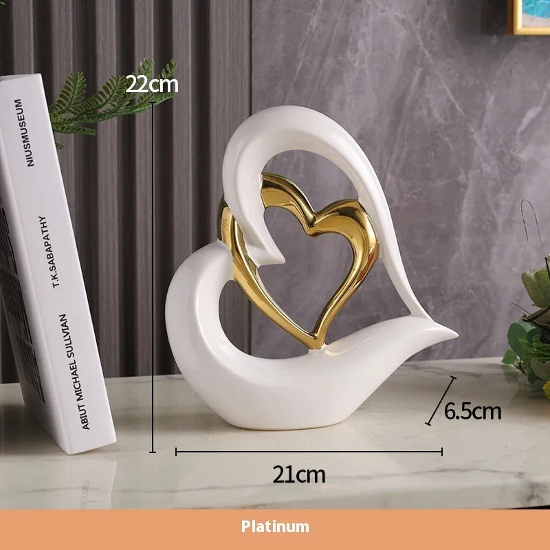 Modern geometric heart ornament in metallic finish displayed on shelf