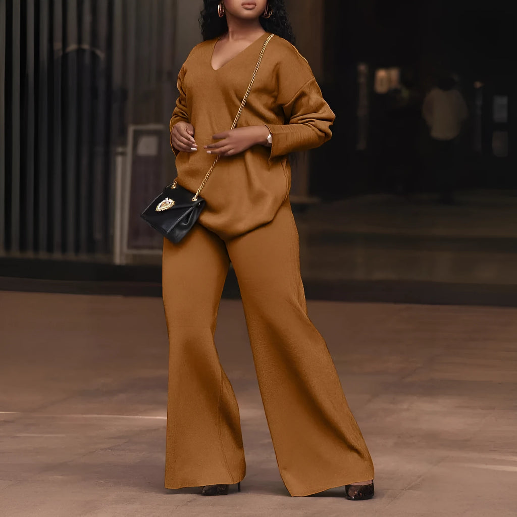 Women's brown thickened velvet two-piece suit with split sleeve top and trousers on a hanger.