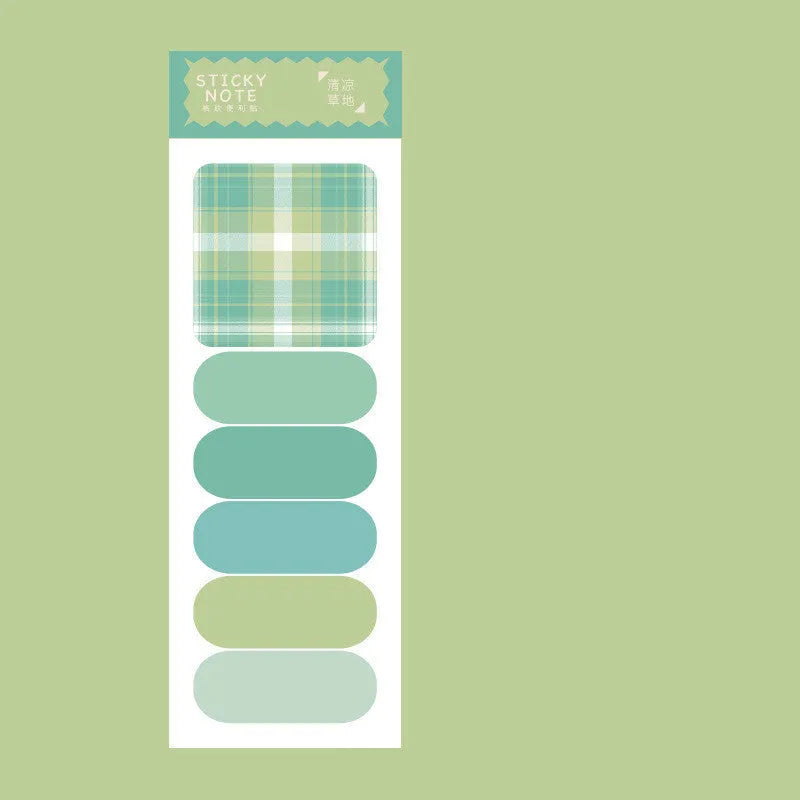 Colourful plaid sticky note memo pad showing eight different designs including blue, pink, and green patterns