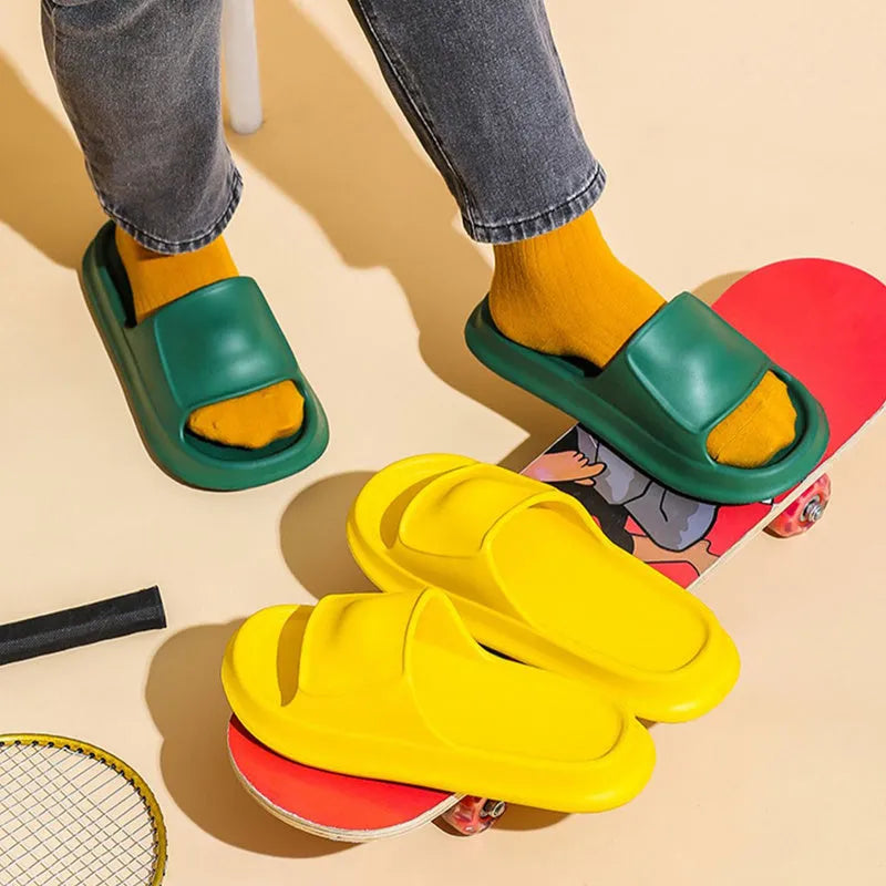 A pair of thick-soled EVA flip-flop slippers on a bathroom floor, showcasing non-slip tread and available colour options.