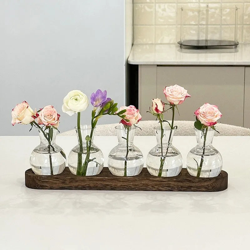Transparent hydroponic vase in wooden frame for water plant display