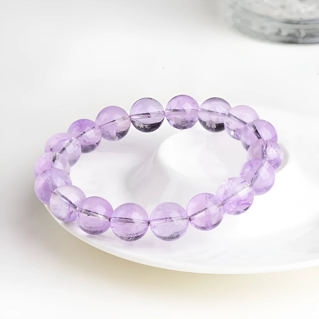 Lavender coloured amethyst crystal bead bracelet with round geometry shape and water ripple design.