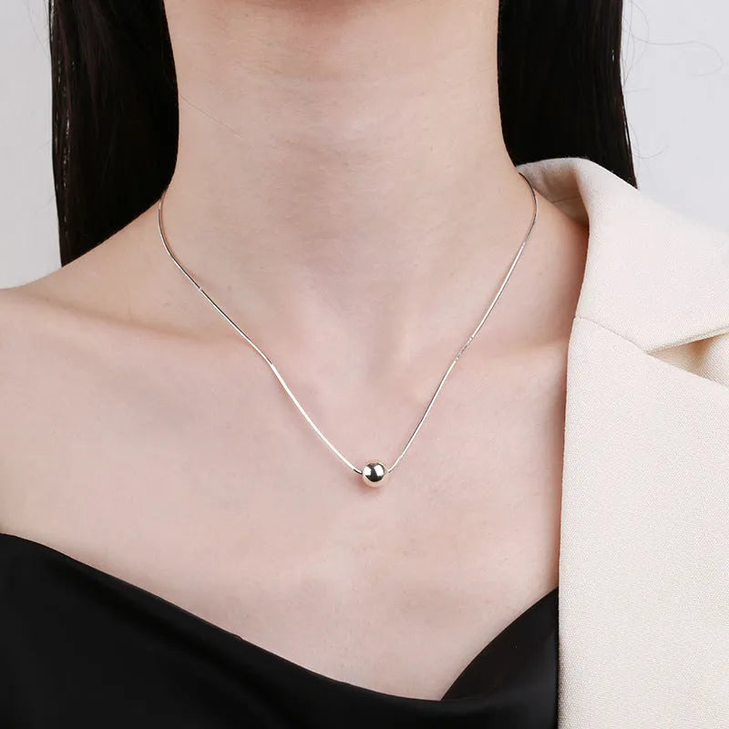 Silver necklace with small ball pendants on delicate chain for clavicle wear