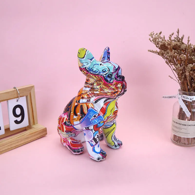 Graffiti coloured solid resin French bulldog statue on a wooden surface.