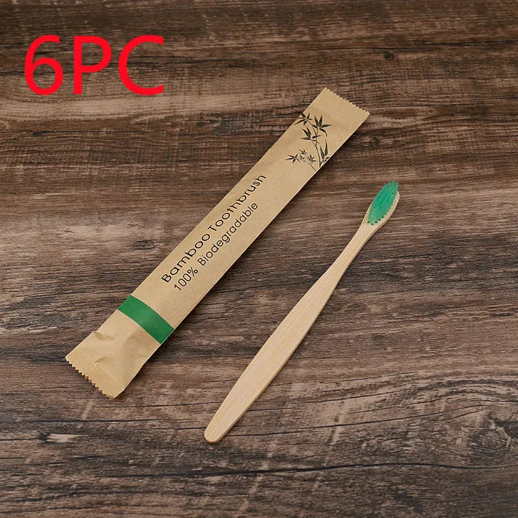 Set of ten bamboo toothbrushes with charcoal bristles in assorted colours on a plain background