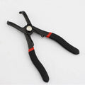 Red round nail removal pliers with PVC handles and adjustable jaws for interior trim work