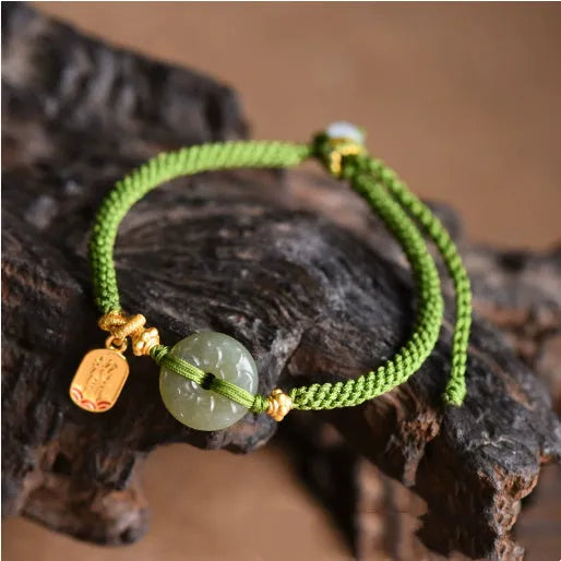 Green rope bracelet with Hetian jade peace buckle fastener, traditional Chinese hand-woven construction