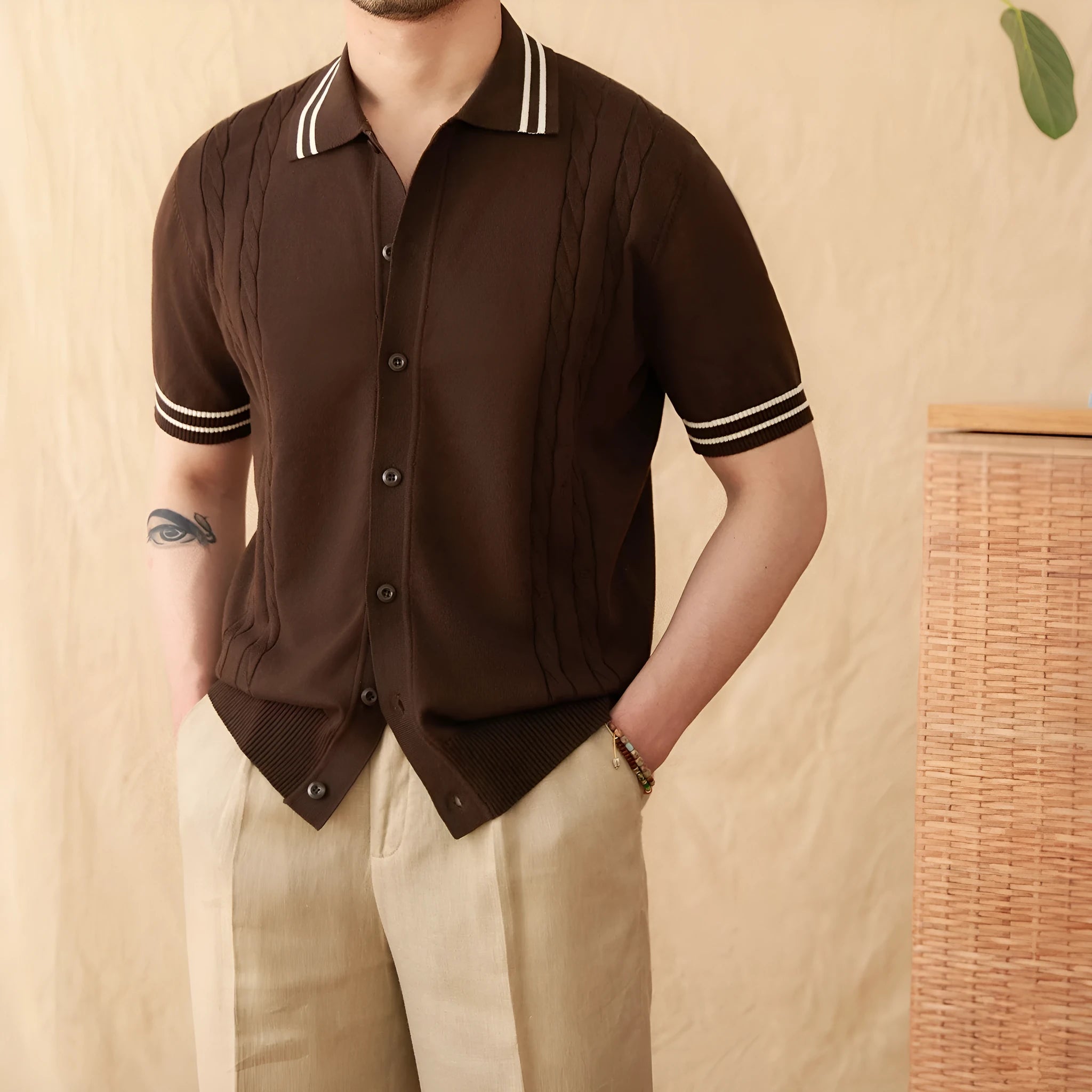 Man wearing a short-sleeved apricot lapel polo shirt made from cotton-polyester blend fabric.