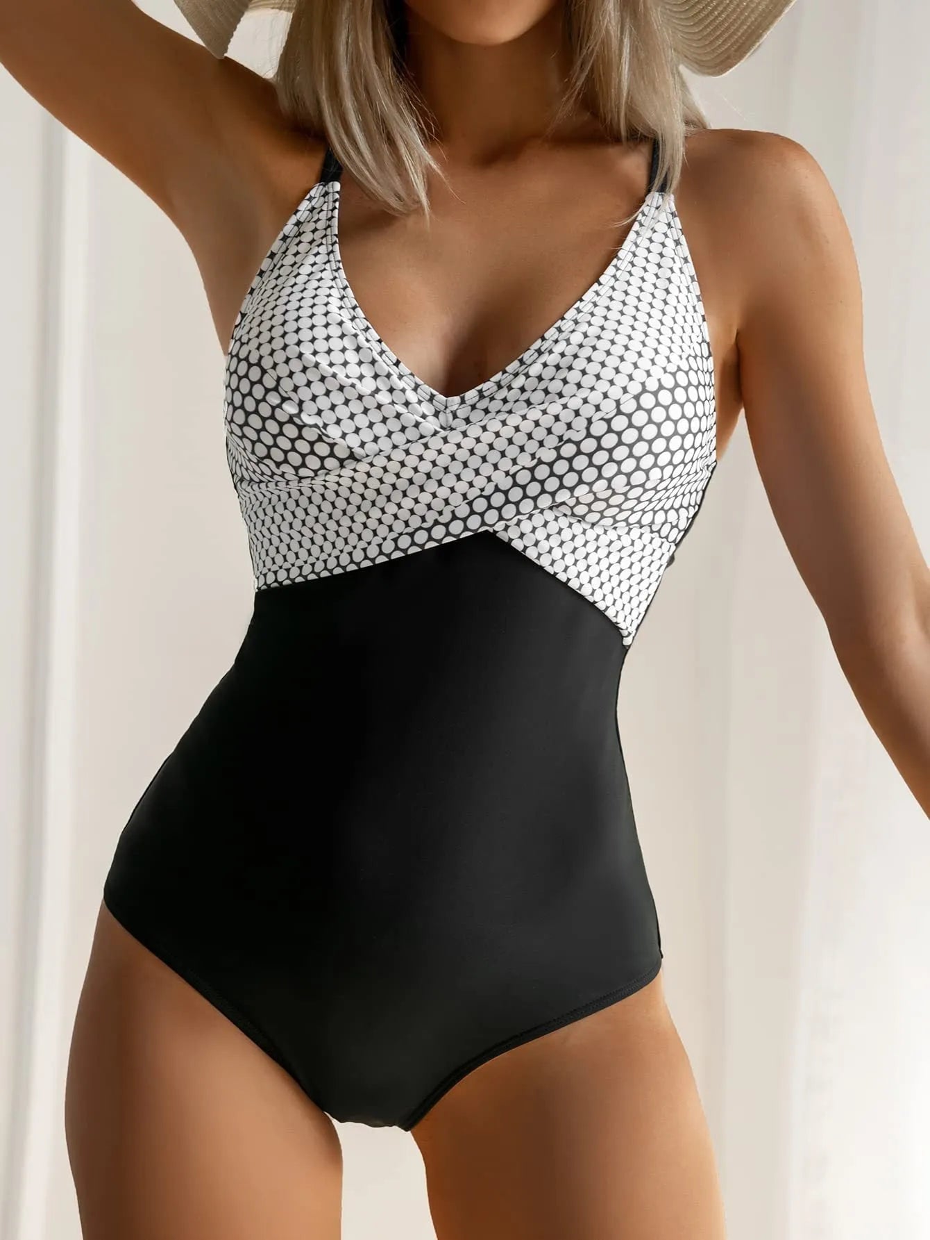 Women's printed one-piece bikini swimsuit with lace-up back detail in a leopard print pattern.