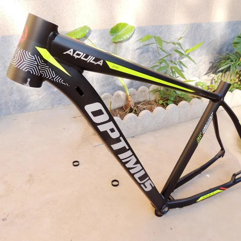 Black green 29-inch aluminium mountain bike frame with disc brake mounts and internal cable routing ports.