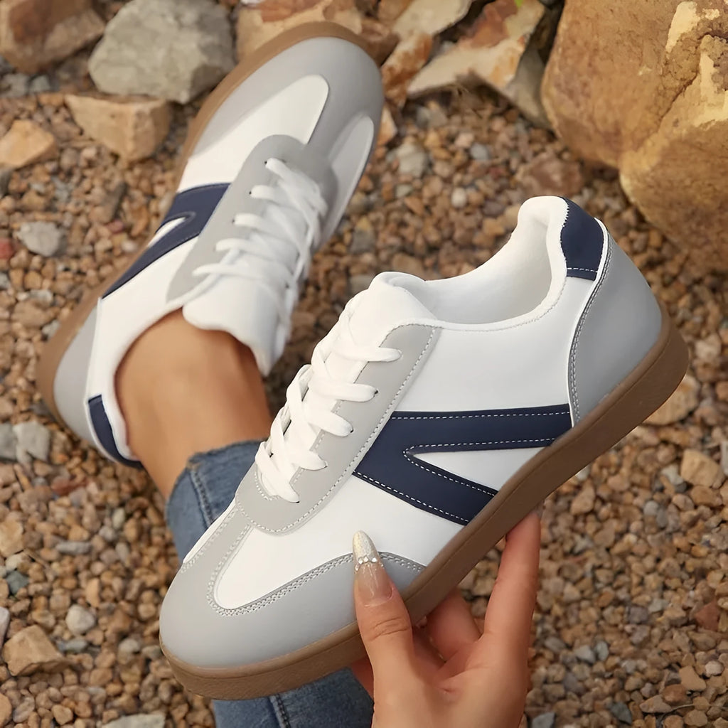 Blue women's low-top training shoes with rubber sole and front lace-up closure