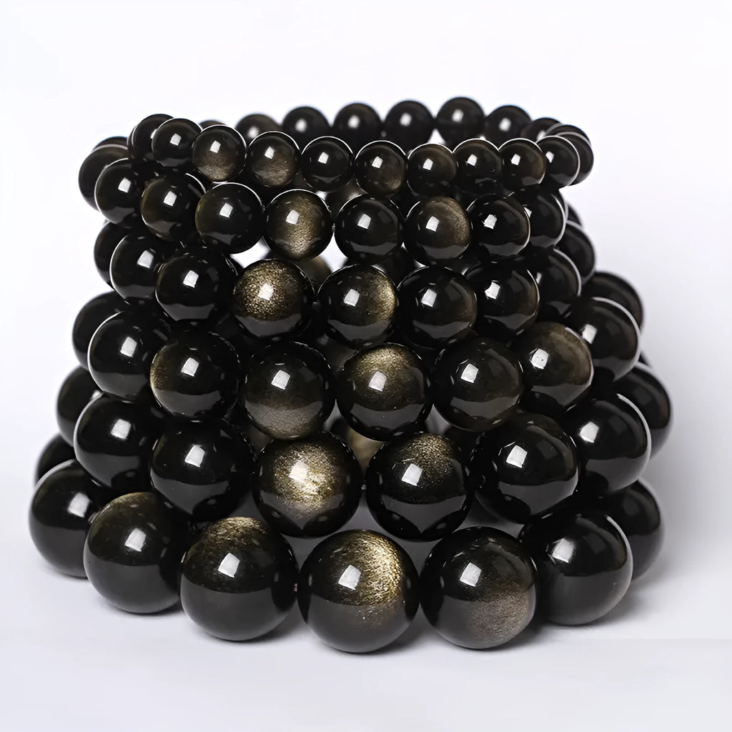 Hand-woven round obsidian bead bracelet on a wrist, showing ethnic style and multiple colour options.