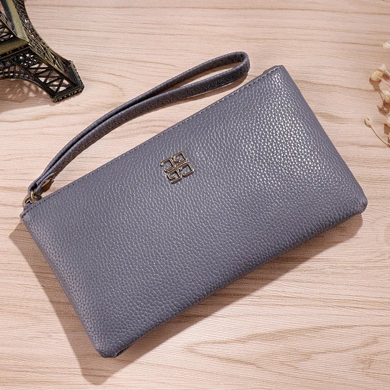 Long slim wine red PU leather wallet handbag with a top zip, shown open to reveal card slots and a phone pocket.
