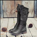 Women's black chunky heel high leg boots with a round toe and low profile.