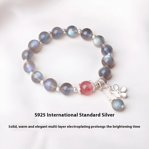 Close-up of a women's 925 sterling silver bracelet with a grey moonstone bead and a zodiac animal charm.
