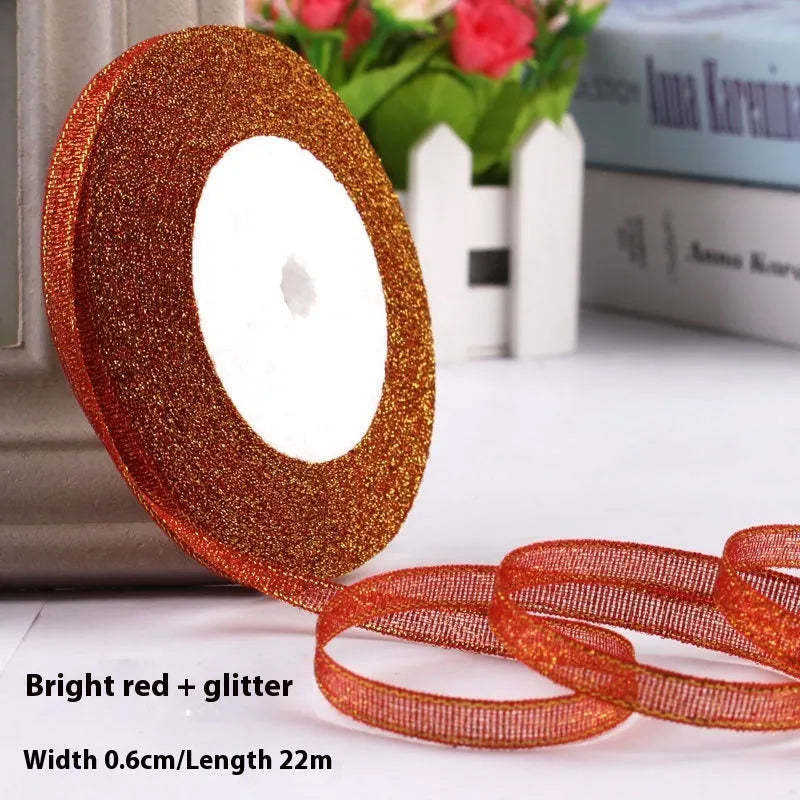 Roll of narrow 0.6cm wide polyester gift ribbon in a multicolour pattern.