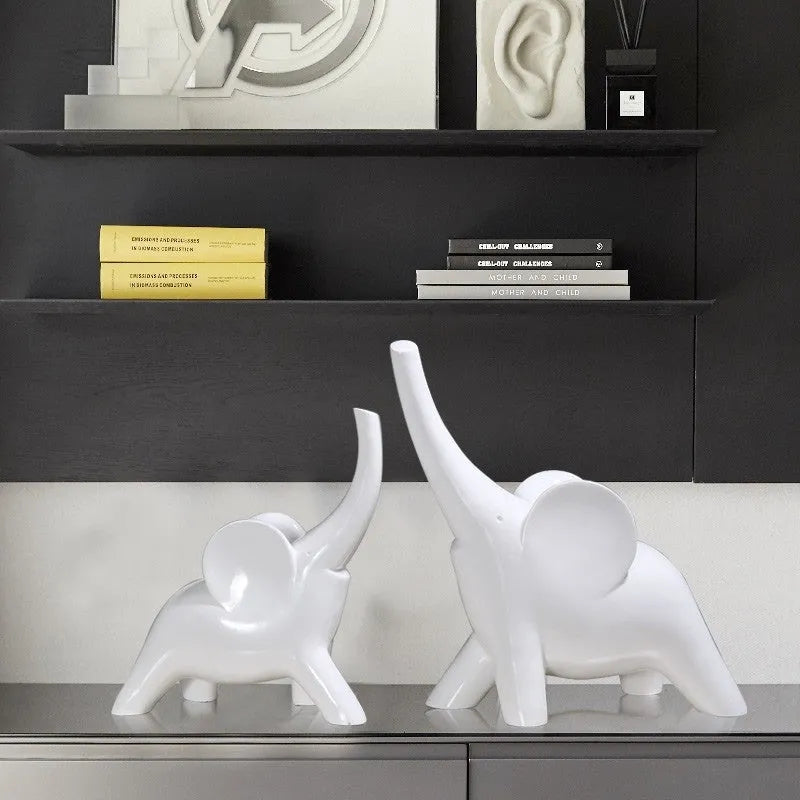 Modern minimalist elephant figurine ornament in rose gold or white resin on a plain background.