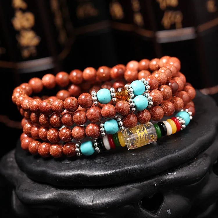 Golden star stone bracelet with 108 nugget sand beads and a fu character charm.
